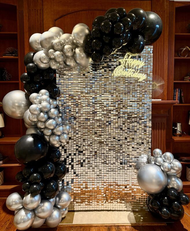 Silver and black shimmer wall birthday setup